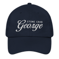 A navy blue baseball cap with white embroidered text reading 'STONE CRAB George' on the front, shown against a plain white background.