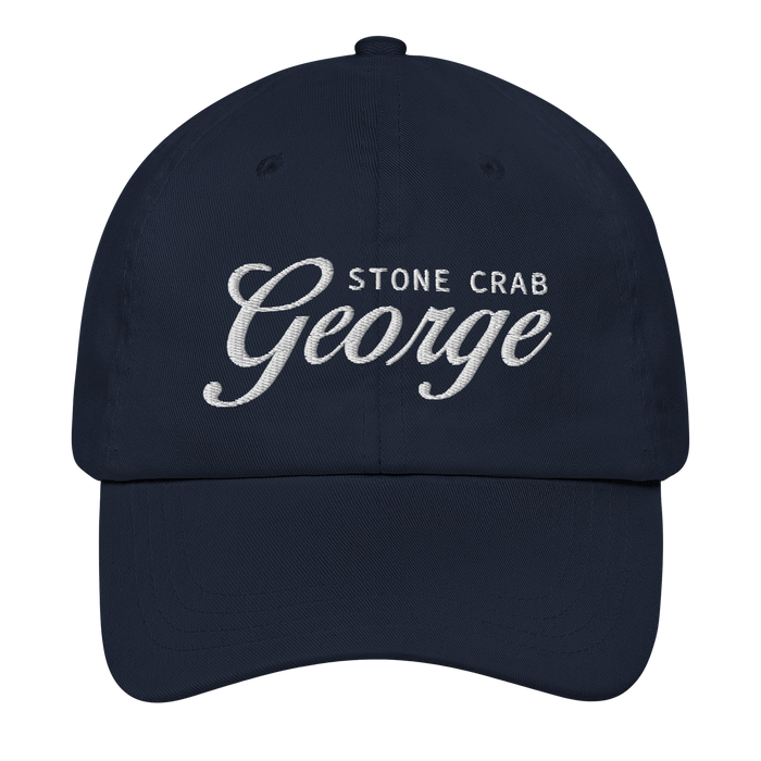 A navy blue baseball cap with white embroidered text reading 'STONE CRAB George' on the front, shown against a plain white background.