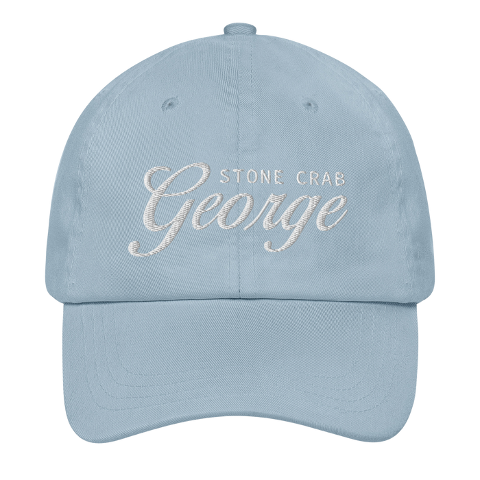A light blue baseball cap with custom embroidered text reading 'STONE CRAB George' on the front, shown against a plain white background.