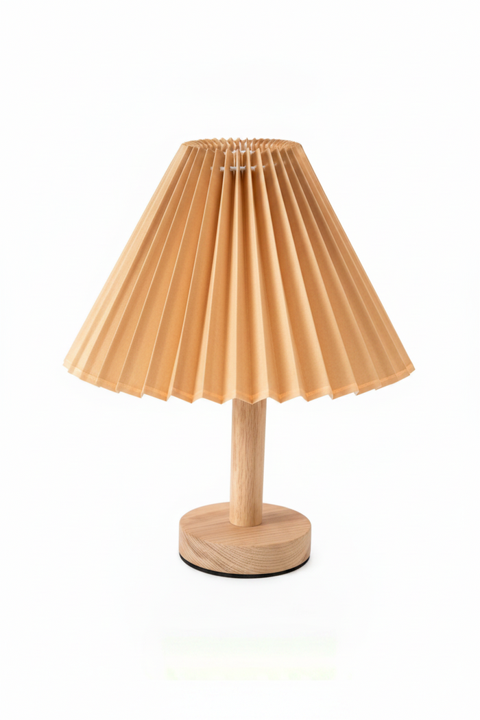 Small table lamp with pleated beige shade on a white background